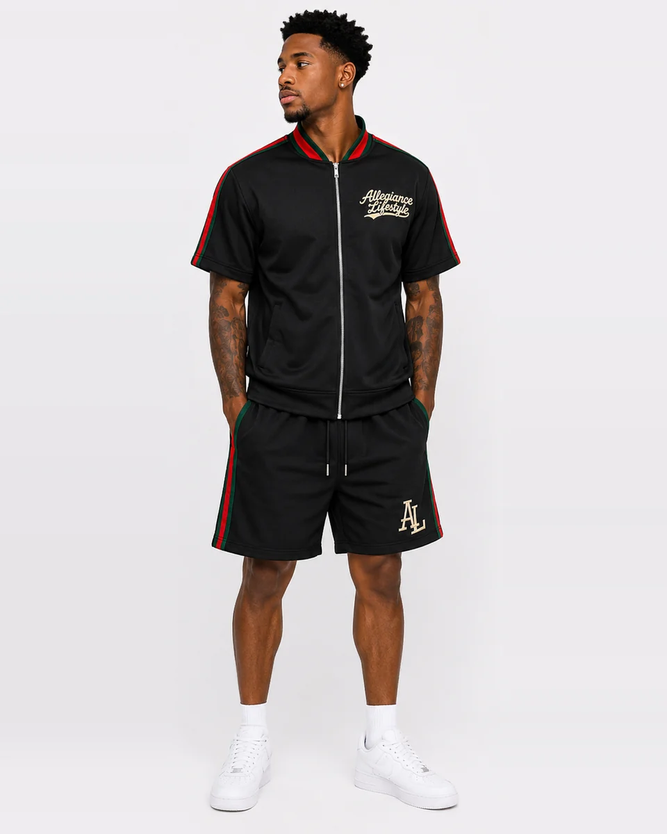 Black short-sleeve zip set with red and green trim by Allegiance Lifestyle
