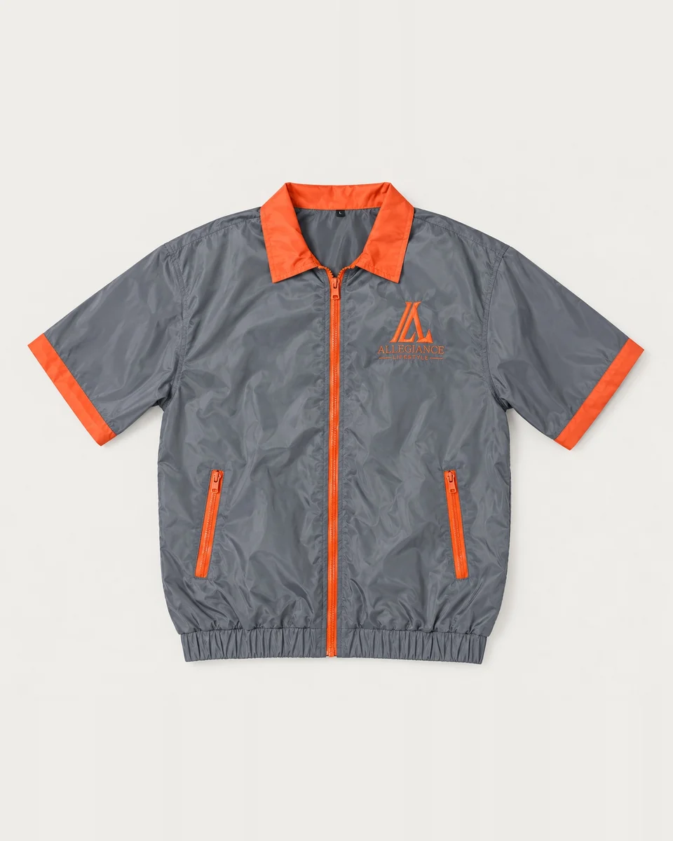Gray short-sleeve zip top with orange collar and trim and matching gray shorts by Allegiance Lifestyle